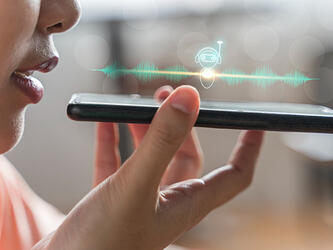 woman using smartphone to speak to AI assistant